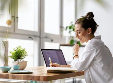 Person smiling at desk.png